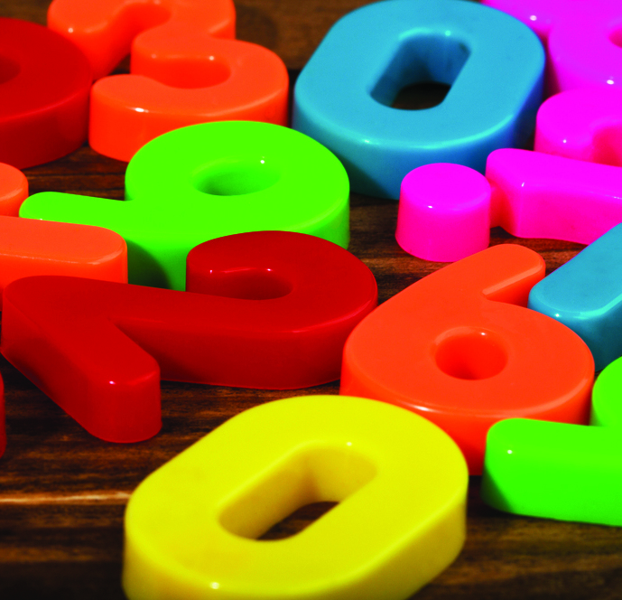 A mixture of colourful plastic numbers on a table