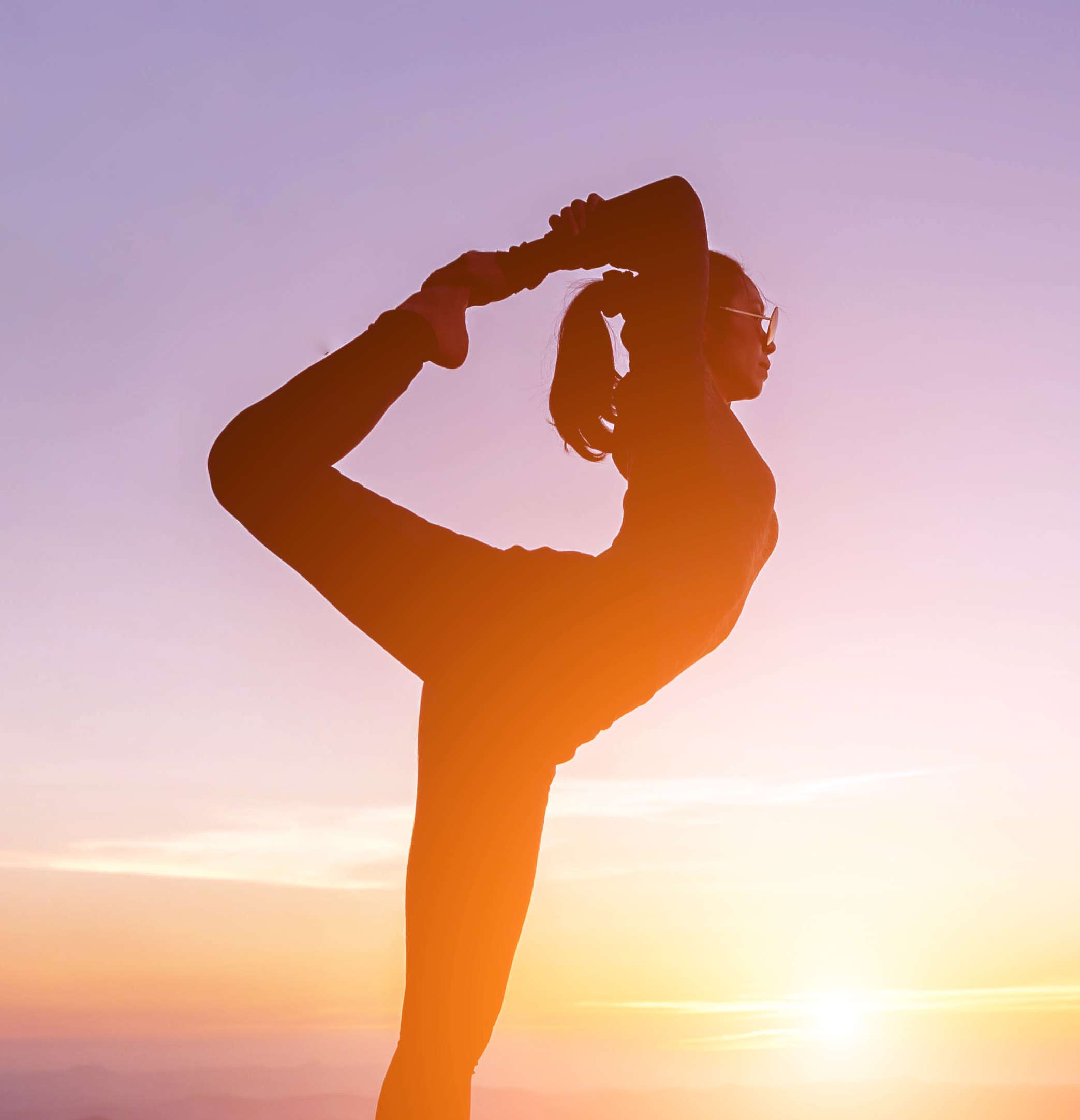 person doing yoga at sunrise
