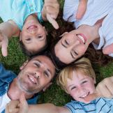 Image of family lying on their backs in circle with heads together