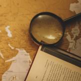 magnifying glass and book on table