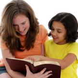 Two people reading a book together