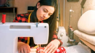 woman using sewing machine