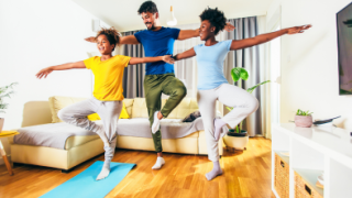 family doing yoga in living room