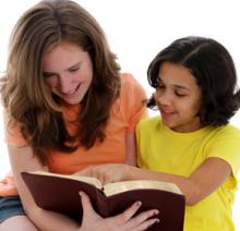 Two people reading a book together